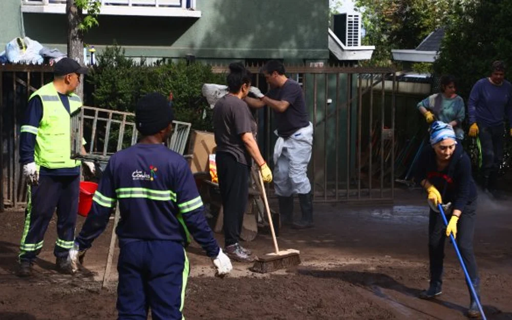Las Condes: barro seco complica la limpieza de viviendas a tres días del aluvión